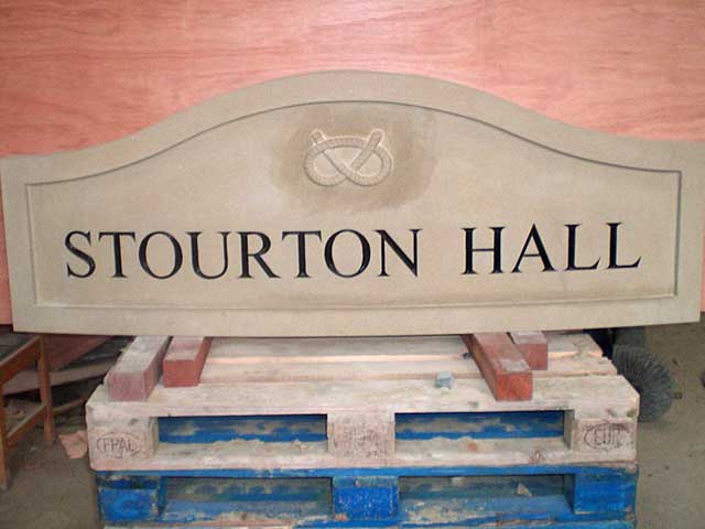 Carved yorkstone house sign